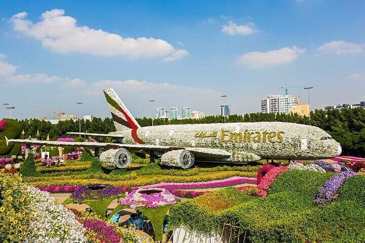 Explore the stunning floral wonder of the Emirates Airbus A380 crafted from thousands of vibrant blooms surrounded by lush gardens inviting visitors to enjoy a unique experience in Dubai.